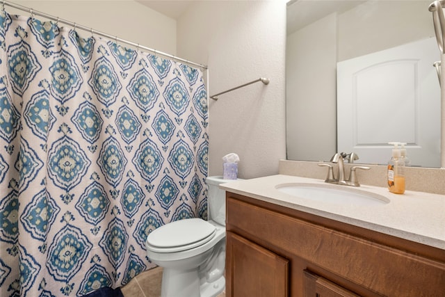 bathroom featuring tile patterned floors, vanity, and toilet