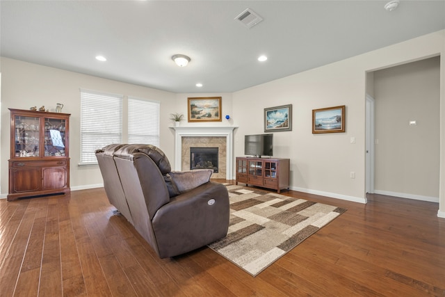 living room featuring dark hardwood / wood-style flooring and a fireplace