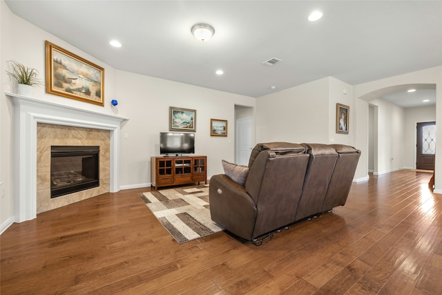 living room featuring a fireplace and dark hardwood / wood-style flooring