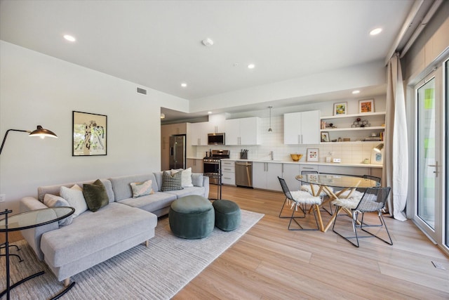 living room with light hardwood / wood-style flooring