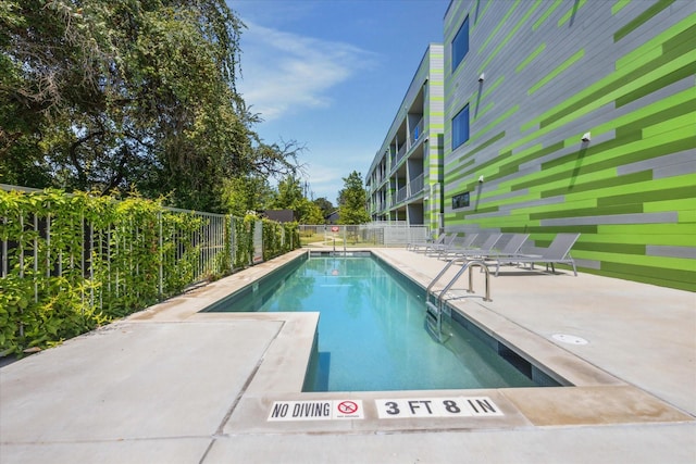 view of swimming pool with a patio