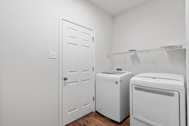 laundry room featuring dark hardwood / wood-style flooring and separate washer and dryer