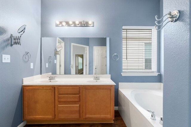 bathroom with a bathtub and vanity