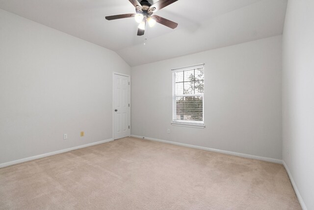 carpeted empty room with ceiling fan and lofted ceiling