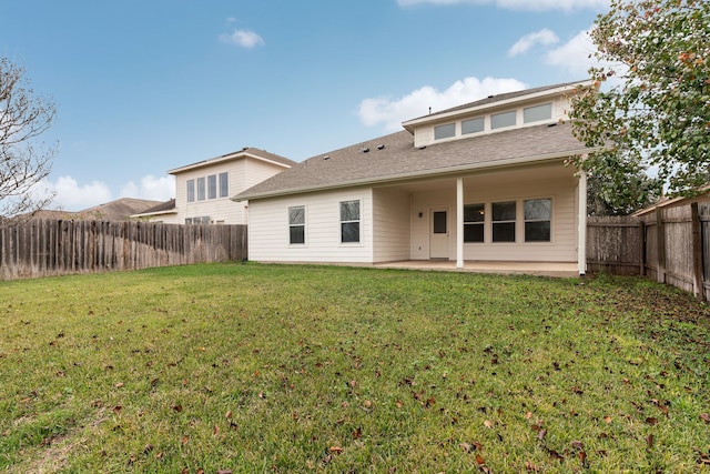 rear view of property with a patio area and a yard