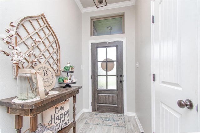 entryway featuring hardwood / wood-style flooring and ornamental molding