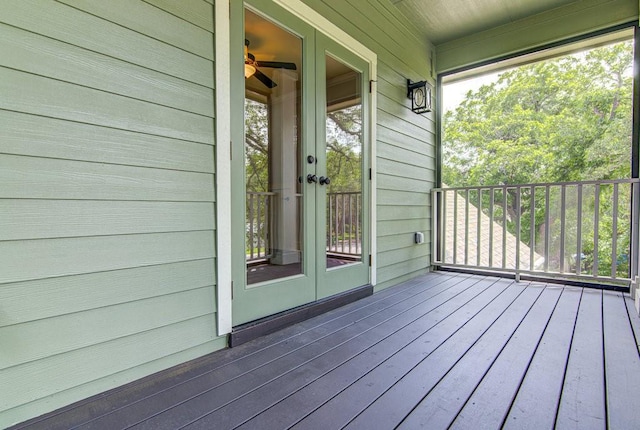 wooden terrace featuring french doors and covered porch