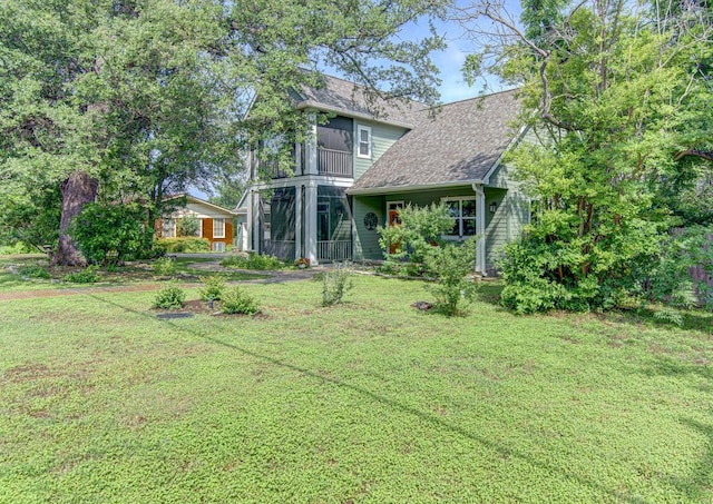 back of house with a lawn and a sunroom