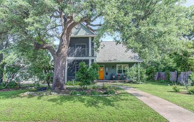 view of front of home with a porch and a front lawn