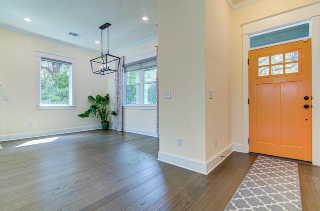 entrance foyer with dark wood-type flooring and ornamental molding