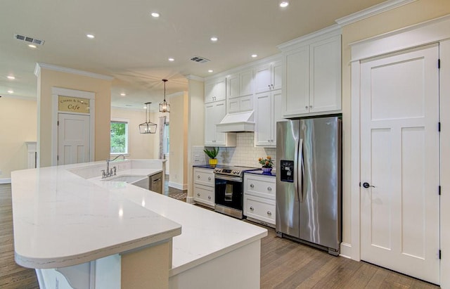 kitchen with appliances with stainless steel finishes, a spacious island, sink, pendant lighting, and white cabinets