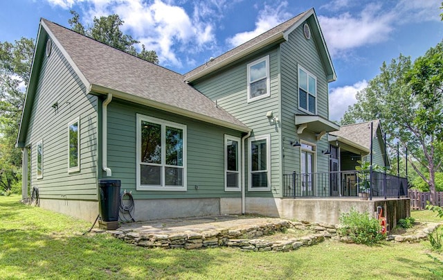 rear view of house with a yard and a patio area