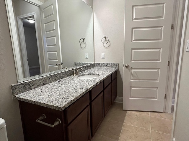 bathroom with tile patterned floors, vanity, and toilet