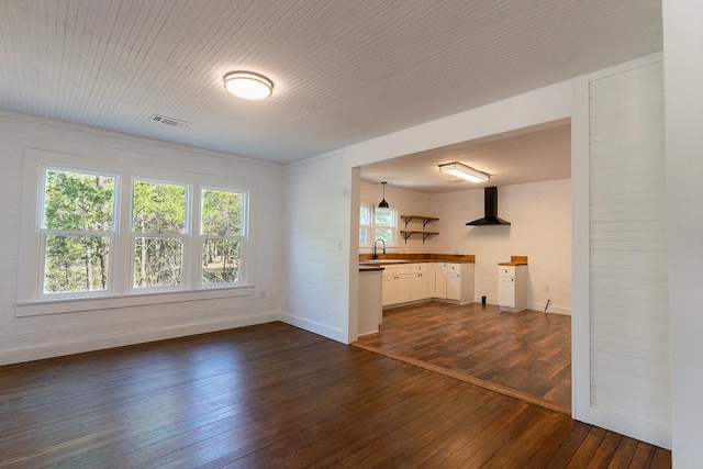 unfurnished living room with dark hardwood / wood-style flooring and sink