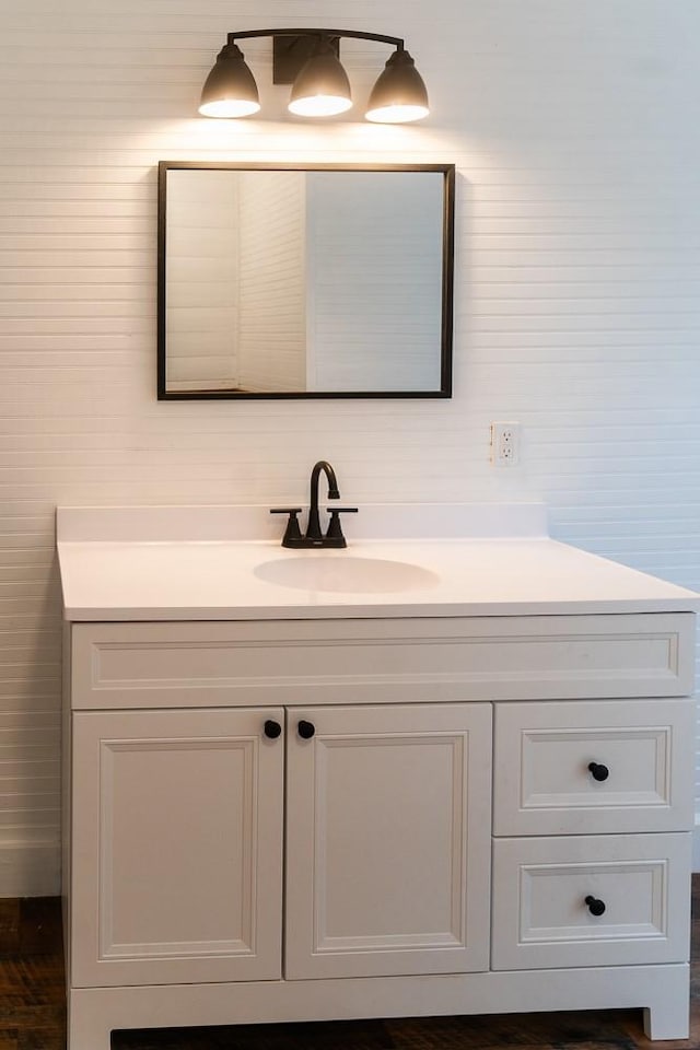 bathroom with hardwood / wood-style floors and vanity