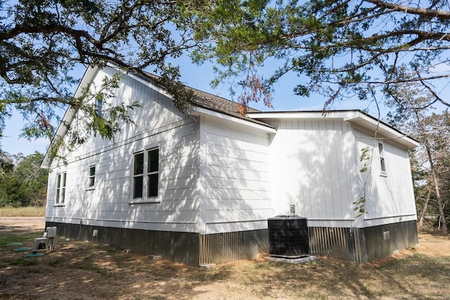 view of side of home featuring central AC