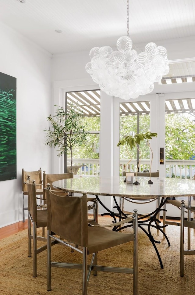 dining room featuring wood-type flooring and a notable chandelier