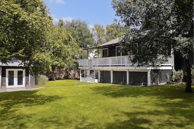 view of yard featuring a deck and french doors