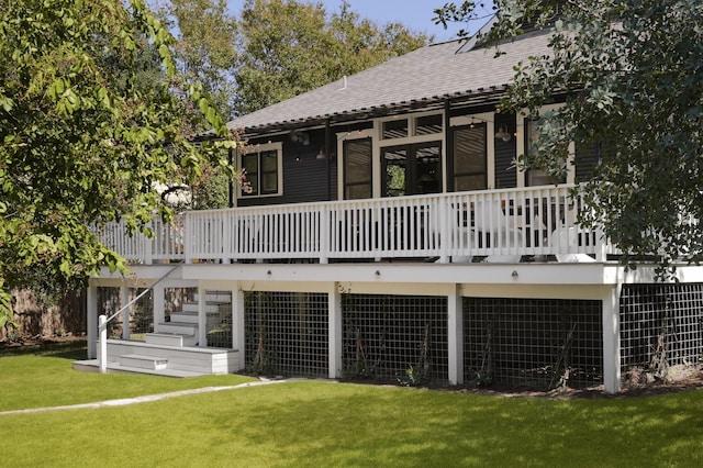 rear view of property with a deck and a lawn