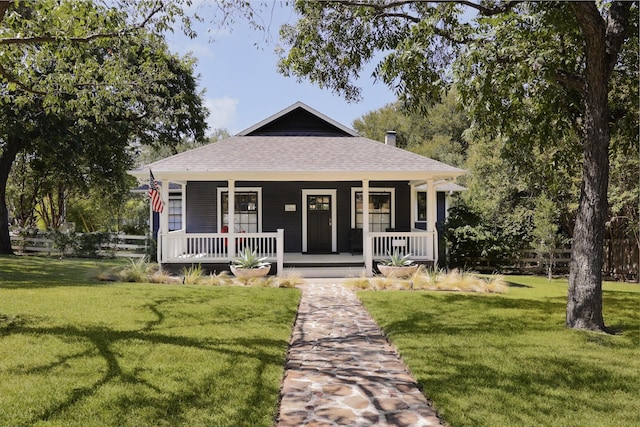 country-style home featuring covered porch and a front yard