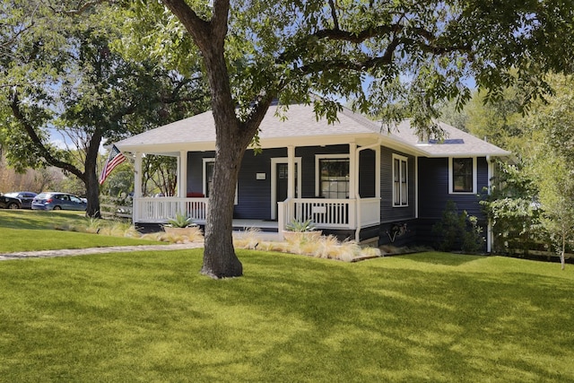 view of front of house with a porch and a front yard