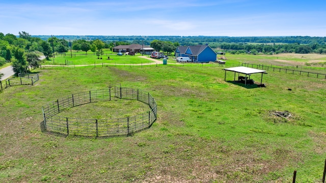 birds eye view of property with a rural view