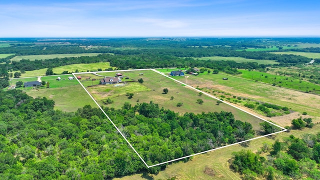 drone / aerial view with a forest view and a rural view