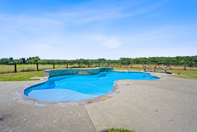 view of swimming pool featuring a patio, fence, and a fenced in pool