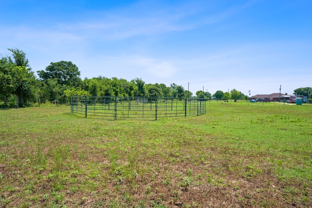 view of yard featuring a rural view and fence