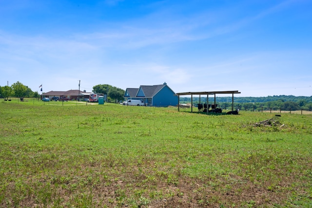 view of yard featuring a carport and a rural view