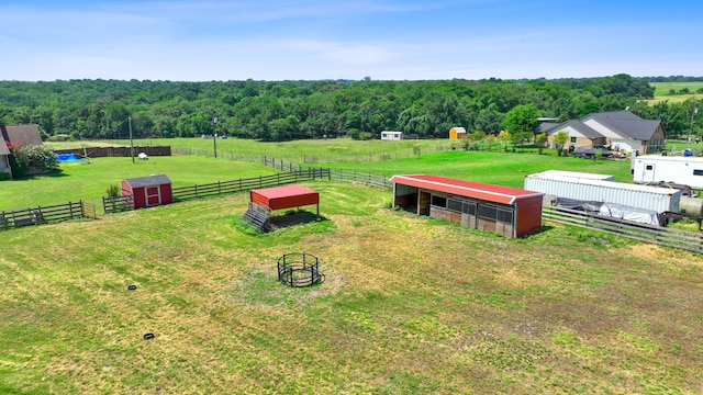 drone / aerial view featuring a forest view and a rural view