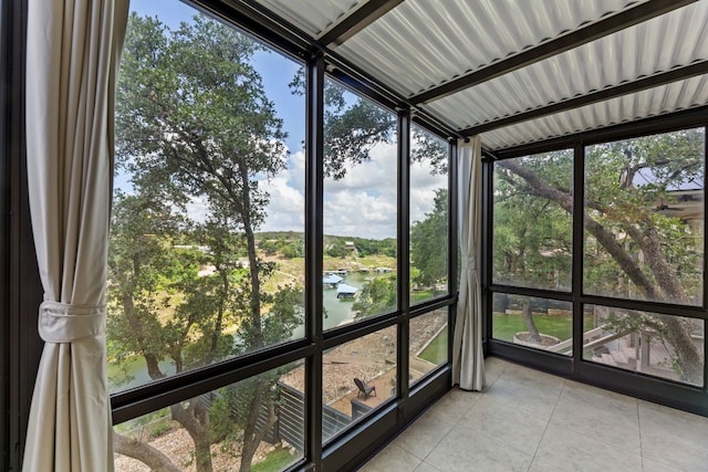 unfurnished sunroom featuring a water view
