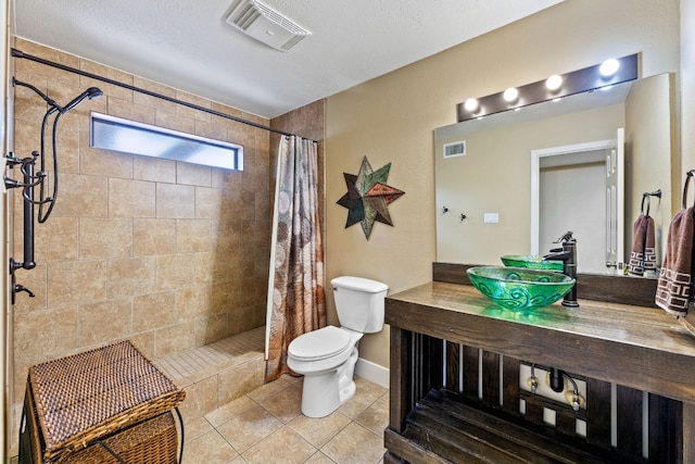 bathroom featuring a shower with curtain, tile patterned floors, vanity, and toilet