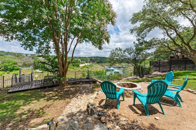 view of yard with a wooden deck and an outdoor fire pit