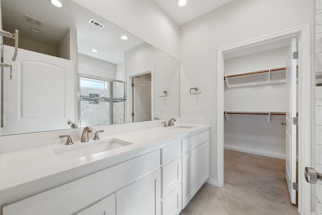 bathroom with vanity and a shower with shower door