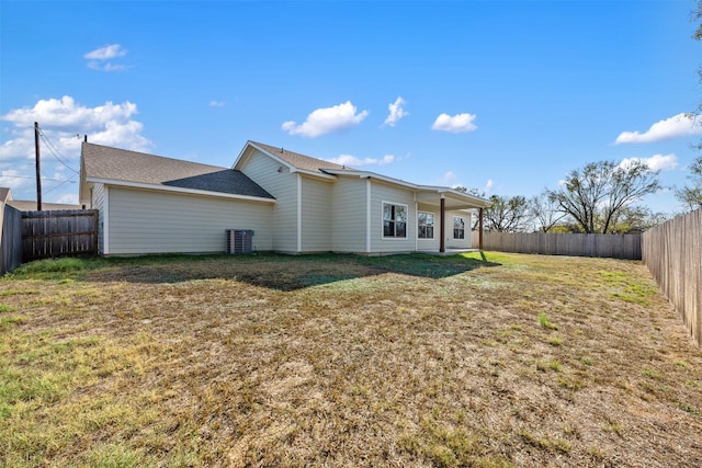 back of property featuring a lawn and cooling unit