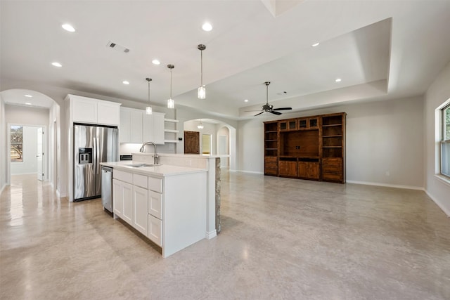 kitchen with sink, white cabinetry, an island with sink, and appliances with stainless steel finishes