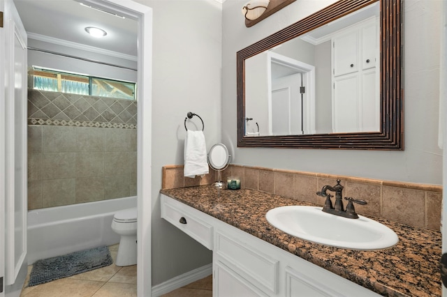 full bathroom featuring tasteful backsplash, vanity, toilet, tiled shower / bath, and tile patterned floors