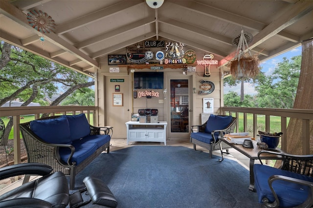 exterior space featuring lofted ceiling with beams and a wealth of natural light