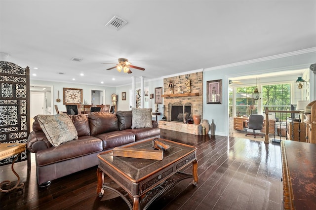 living room with dark wood-type flooring, crown molding, a brick fireplace, and ceiling fan