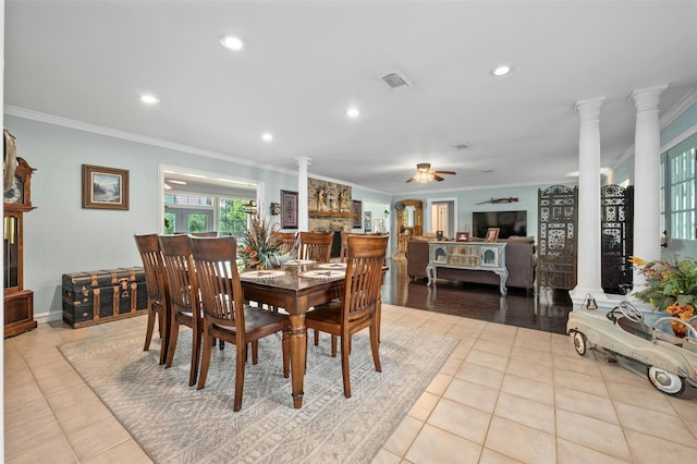 dining area featuring ceiling fan, light tile patterned flooring, ornamental molding, and ornate columns