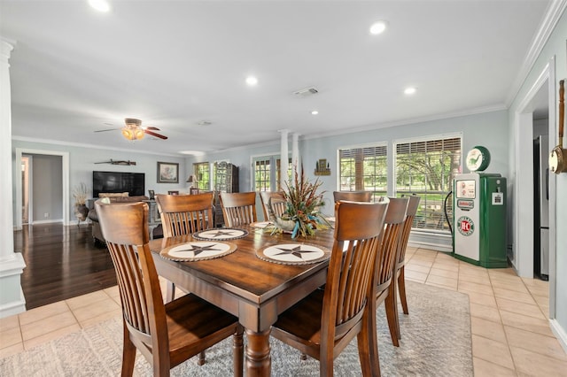 tiled dining space with ceiling fan, ornamental molding, and ornate columns