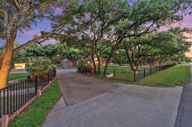 view of home's community with a lawn and a garage