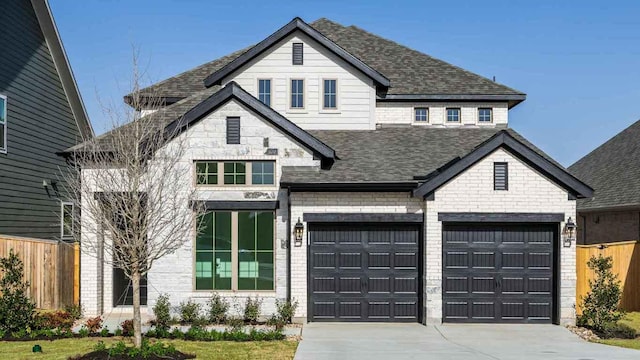 view of front of house featuring concrete driveway, a shingled roof, an attached garage, and fence