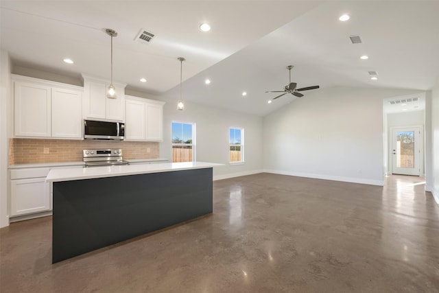 kitchen featuring white cabinets, a center island, lofted ceiling, and stainless steel appliances