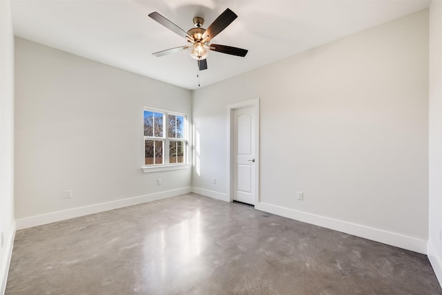 spare room featuring concrete flooring and ceiling fan