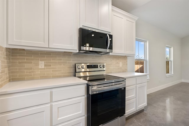 kitchen with tasteful backsplash, white cabinetry, and appliances with stainless steel finishes