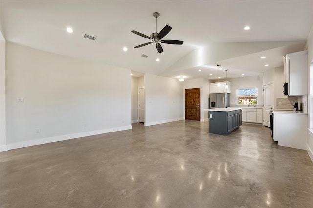 unfurnished living room with concrete flooring, vaulted ceiling, and ceiling fan