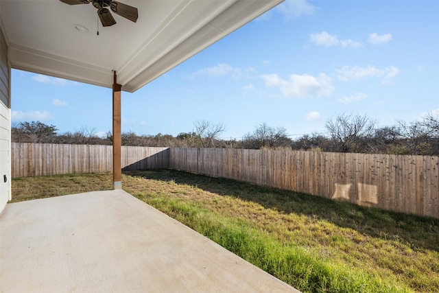 view of yard with ceiling fan and a patio