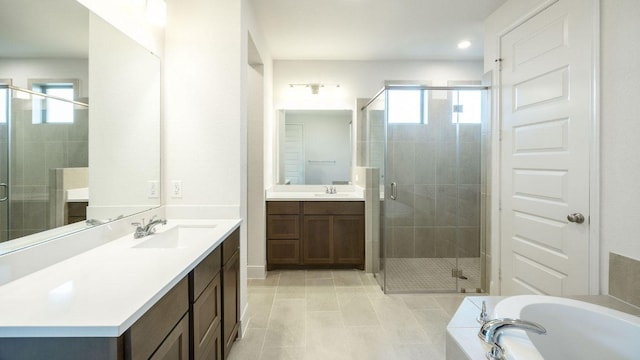 bathroom featuring plenty of natural light, a stall shower, and recessed lighting